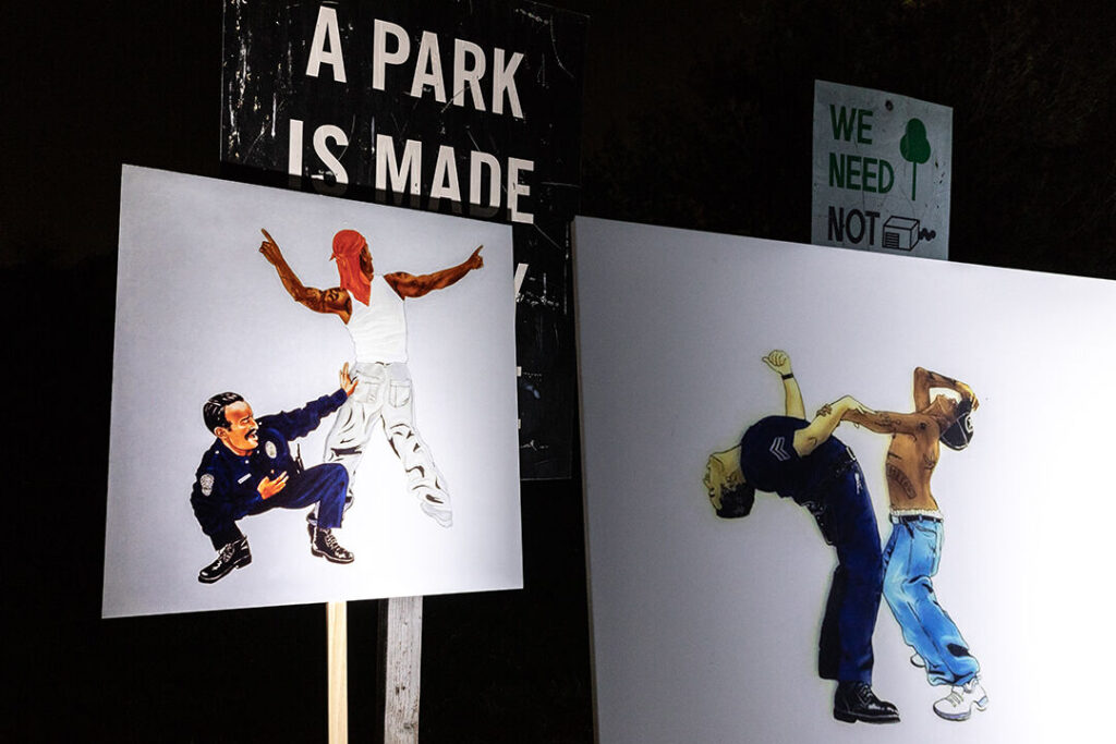 Various artworks of Alex Donis displayed at LA Historic Park on picket posts.