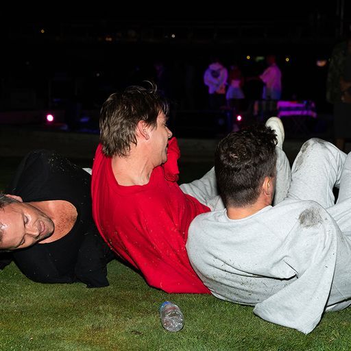 Tim Reid, Brian Getnick, and Arne Gjelten rolling around in grass patch at LA Historic Park wearing sweatpants and crewneck sweaters. Part of their performance piece for XaMENing Masculinities that took place on the night of October 6th, 2022.